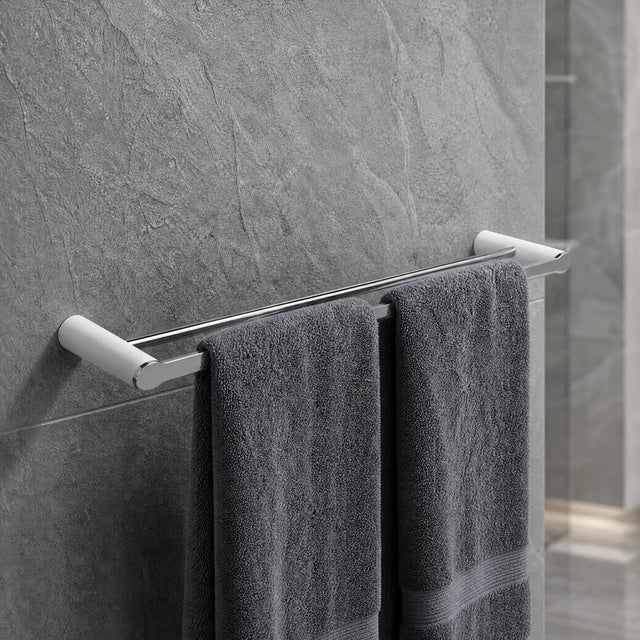 Gray towels hanging on a towel rack in a bathroom with tiled walls and floor.