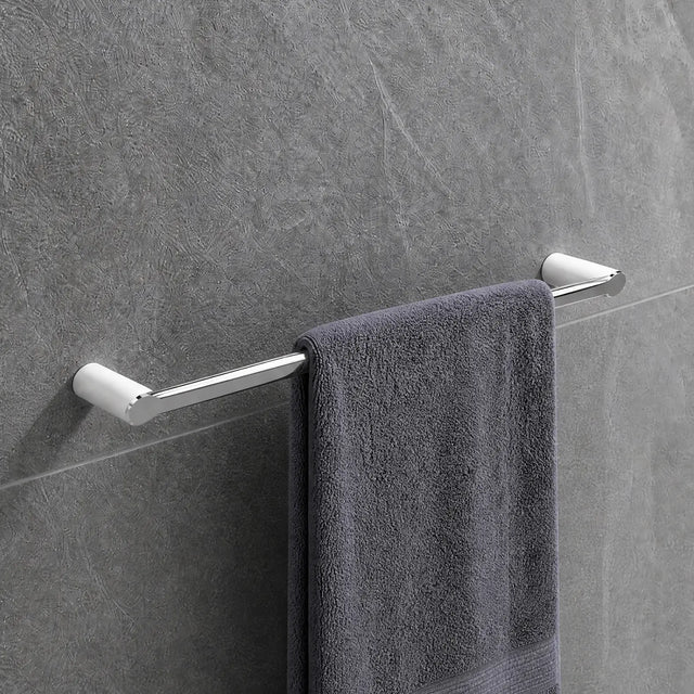 Gray towel hanging on a towel rack in a modern bathroom with tiled walls.