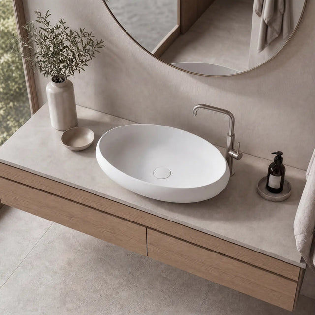 Bathroom vanity with a white sink, wooden cabinet, and decorative elements.
