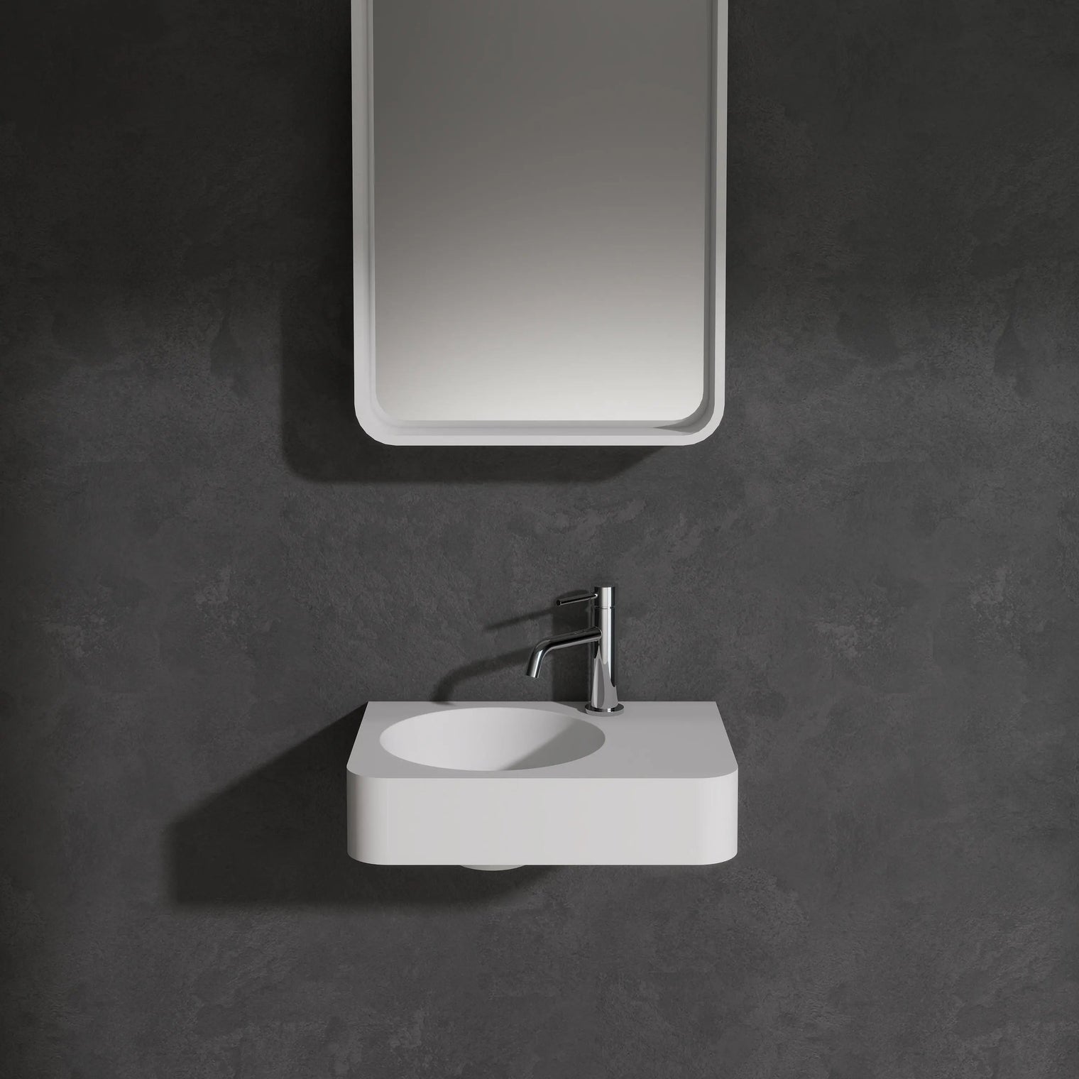 Bathroom setup with a mirror and sink against a dark wall