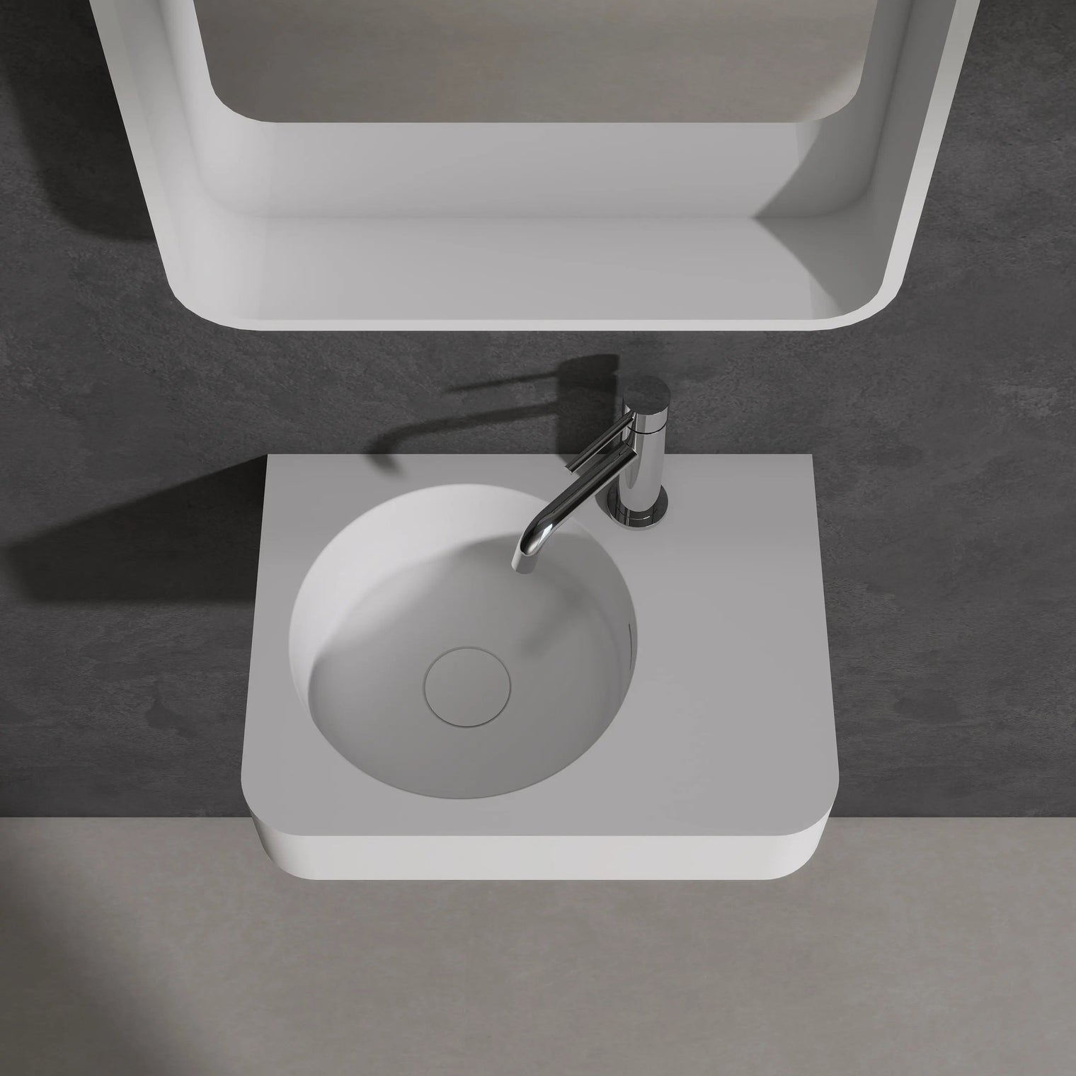 Modern bathroom sink with mirror above on a dark gray wall.