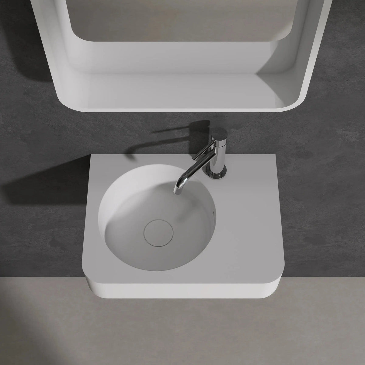 Modern bathroom sink with mirror above on a dark gray wall.