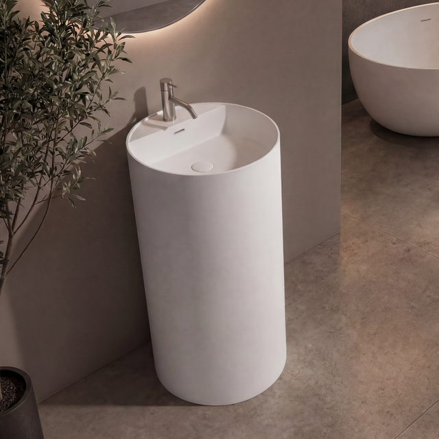 Modern bathroom with a freestanding sink and oval bathtub.