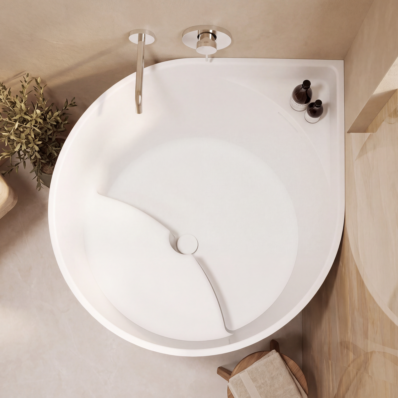 A top-down view of a white corner bathtub with a chrome faucet and drain, styled in a warm beige bathroom with plants and wooden accents.