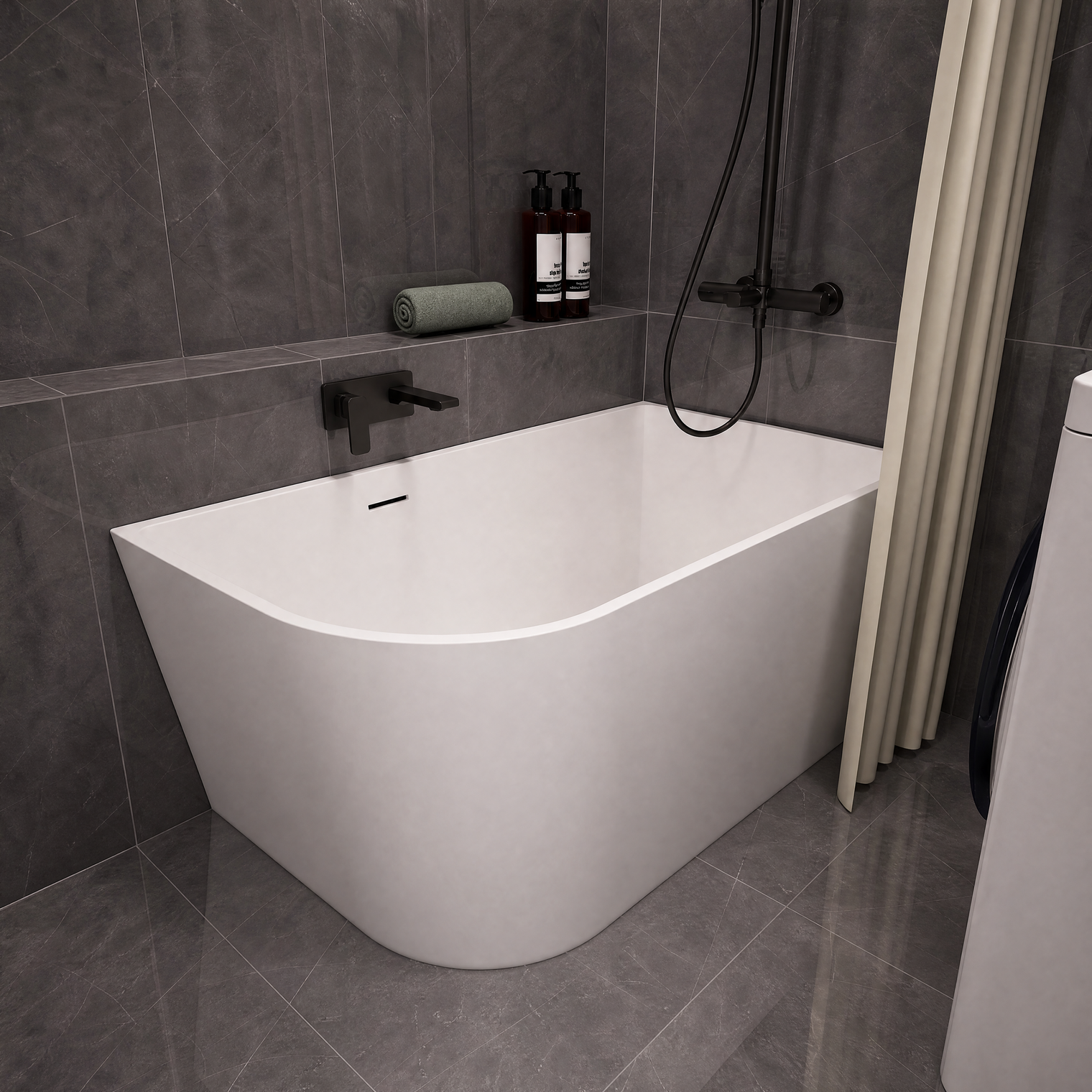 A modern freestanding bathtub with a curved corner design, shown installed in a bathroom with dark gray tiled walls and floor. The tub is white with matte black fixtures, including a wall-mounted faucet and shower system.