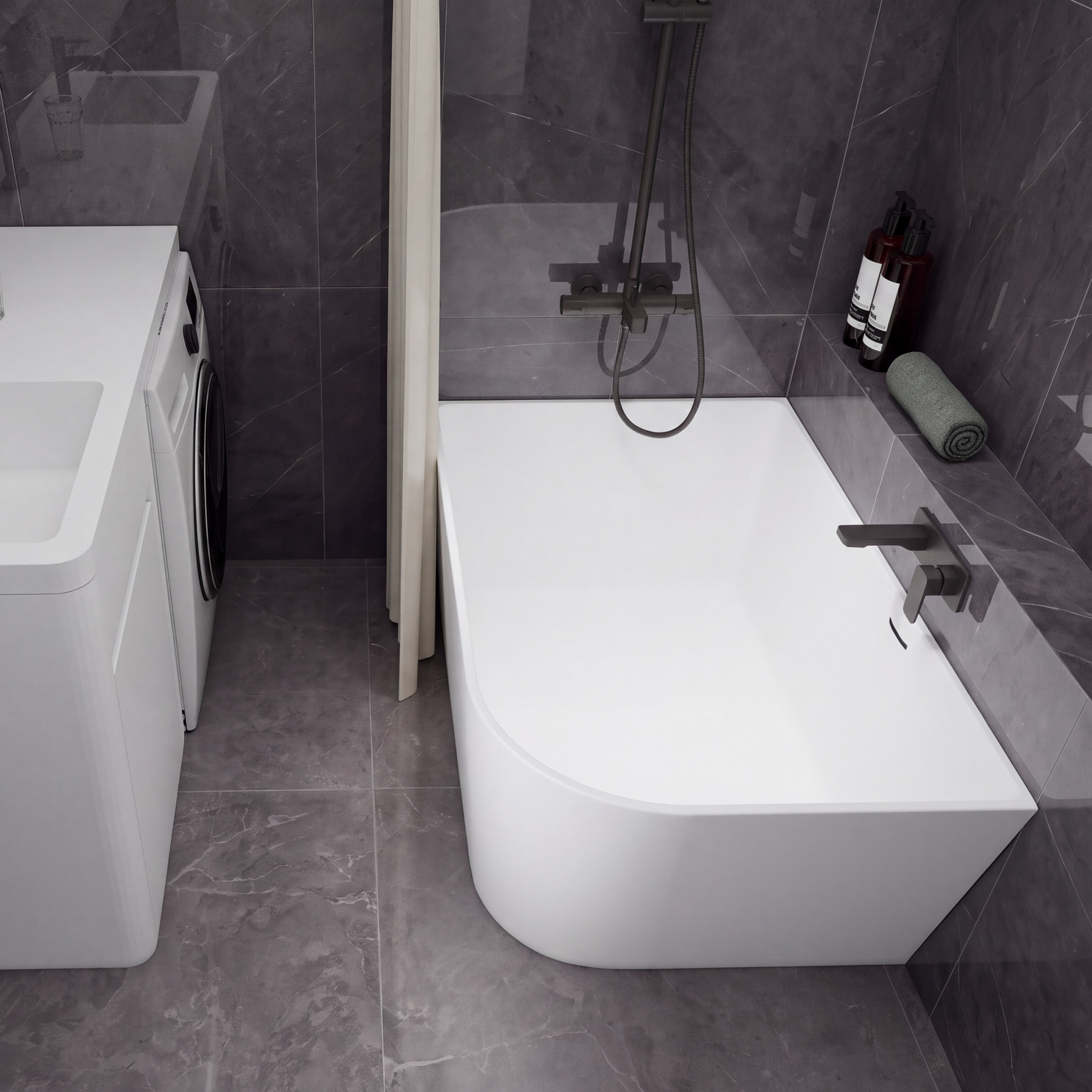 A modern bathroom setup featuring a white freestanding bathtub with a dark wall-mounted faucet and shower system, alongside a white sink vanity with a matching dark faucet and a small washing machine, all set against dark gray tiled walls and floor.