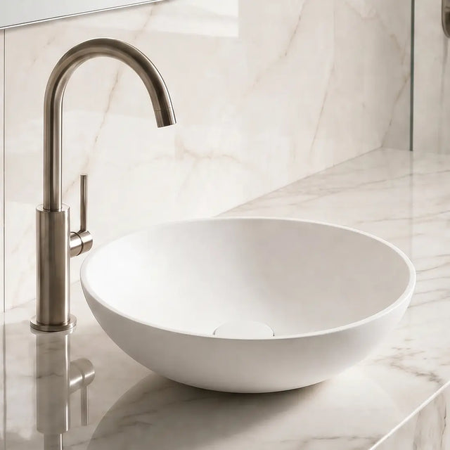 Bathroom sink with marble countertop and tiled wall
