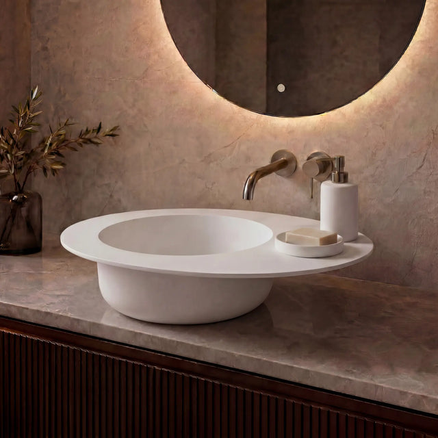 Modern bathroom vanity with a white sink, illuminated mirror, and decorative elements.