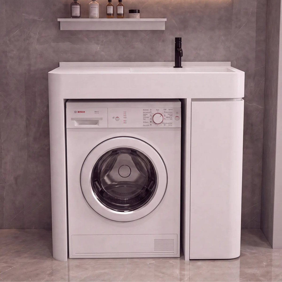 A white Bosch front-loading washing machine integrated into a matching white sideboard cabinet, set against a gray tiled wall with a small shelf holding bottles above.