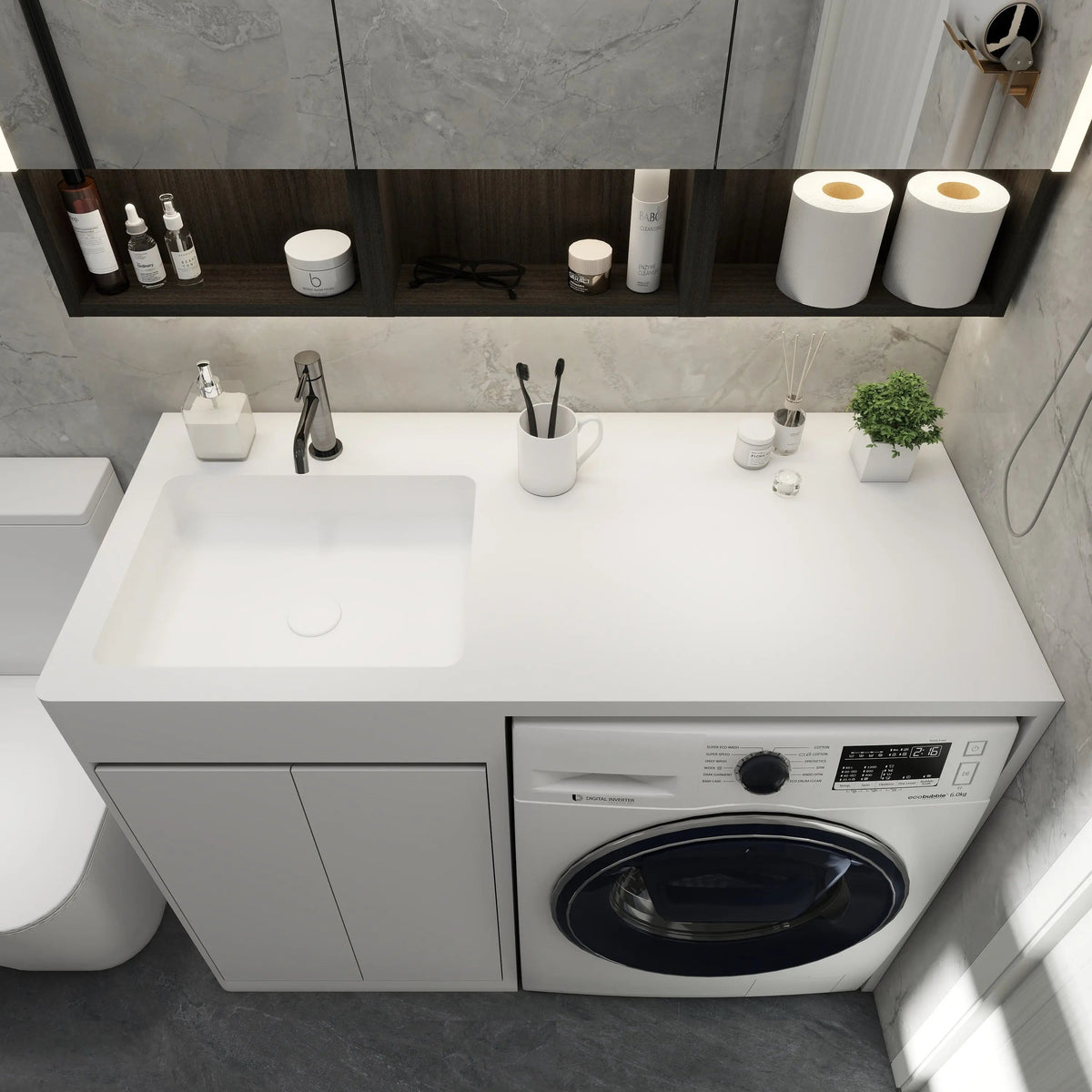 Modern bathroom with a vanity unit, toilet, and washing machine.