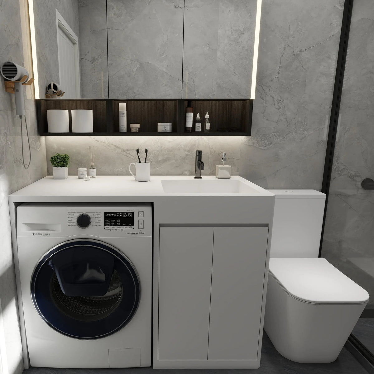 Modern bathroom with washing machine, sink, and toilet.