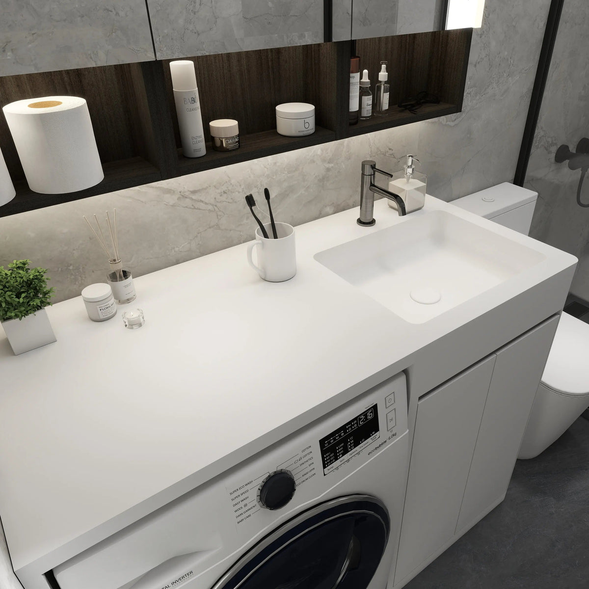 Modern bathroom with washing machine, sink, and various toiletries.