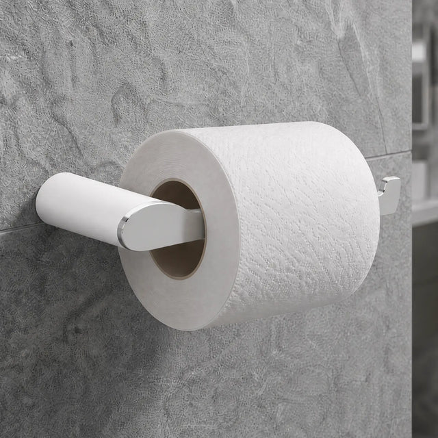 Roll of toilet paper on a holder against a tiled bathroom wall.