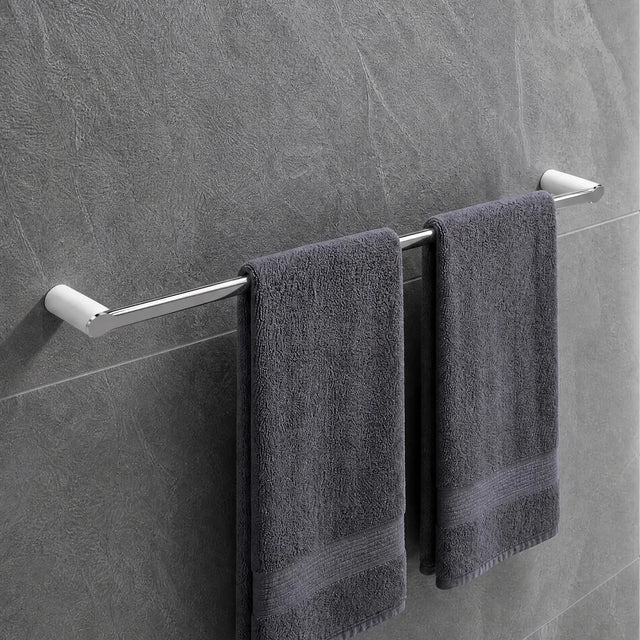 Gray towels hanging on a towel rack in a modern bathroom with tiled walls and a shower.