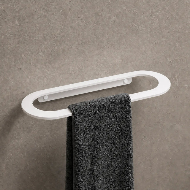 Towel rack with a black towel on a gray wall in a bathroom setting.
