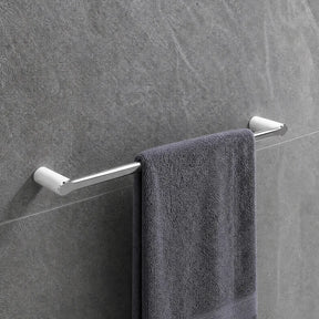 Gray towel hanging on a towel rack in a modern bathroom with tiled walls.