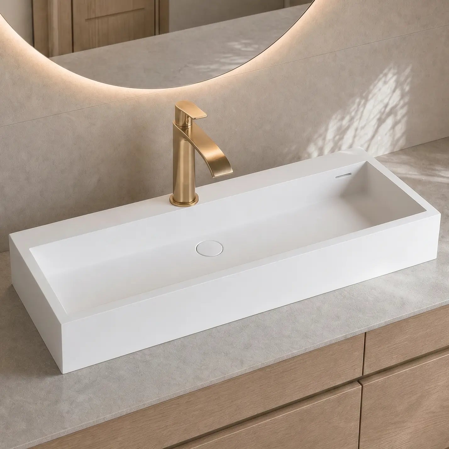 Modern bathroom vanity with a white sink and gold faucet.