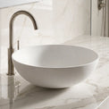 Bathroom sink with marble countertop and tiled wall