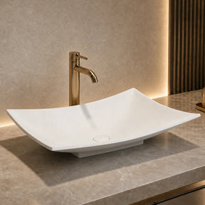 Modern bathroom solid surfaces sink with faucet on a marble countertop