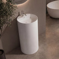 Modern bathroom with a freestanding sink and oval bathtub.