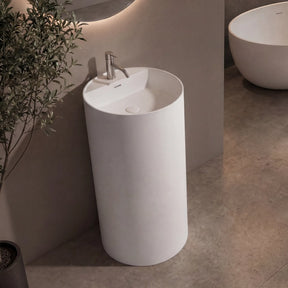Modern bathroom with a freestanding sink and oval bathtub.