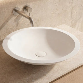 Bathroom sink with faucet on a beige countertop