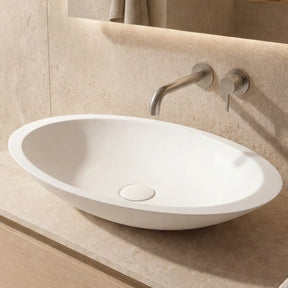 Bathroom vanity with a white sink and silver faucet.