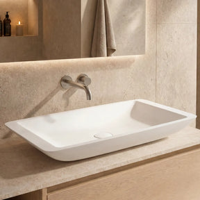 Bathroom vanity with a white sink and wooden cabinet.