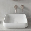Modern bathroom setup with a white sink, round mirror, and minimal decor.