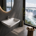 A modern wall-mounted white sink with a chrome faucet in a dark gray bathroom, featuring a large oval mirror and a floor-to-ceiling window with a view of a waterfall.