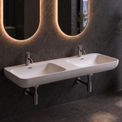 A modern double-sink bathroom wall setup with two illuminated oval mirrors, a white floating basin, chrome faucets, a towel bar, and a large window overlooking a waterfall landscape.
