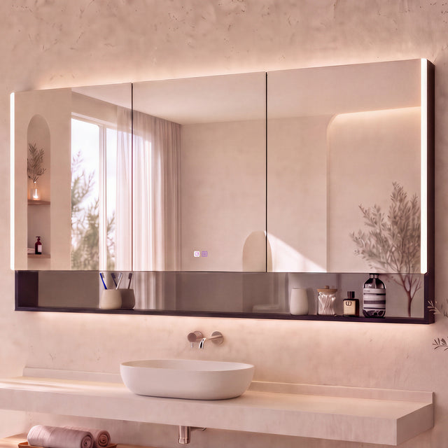 A modern bathroom vanity featuring a large rectangular wall mirror with a dark reflective base, mounted above a floating stone sink and wooden console. The room has warm beige textured walls, built-in shelves with candles and decor, and a window on the left with sheer curtains.