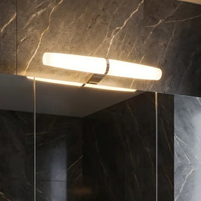Bathroom vanity with a large mirror in a dark marble setting