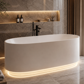 A modern luxury bathroom featuring a freestanding oval bathtub with warm under-light, marble walls and floor, a floating double vanity with a white vessel sink, and a large mirror.