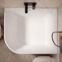 A top-down view of a modern freestanding bathtub in a bathroom setting with gray marble tiles, matte black fixtures, and a small basket of towels on the side.