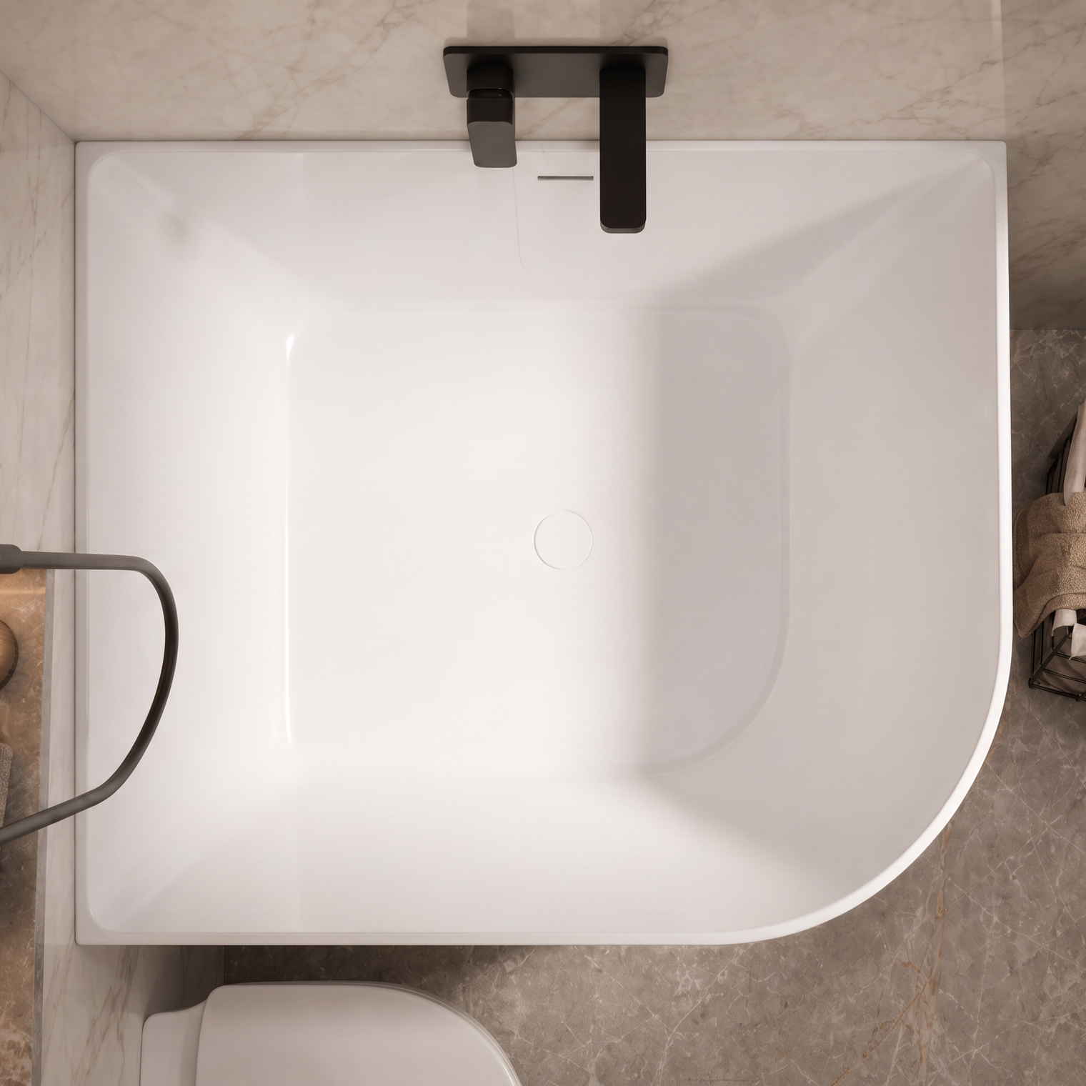 A top-down view of a modern freestanding bathtub in a bathroom setting with gray marble tiles, matte black fixtures, and a small basket of towels on the side.