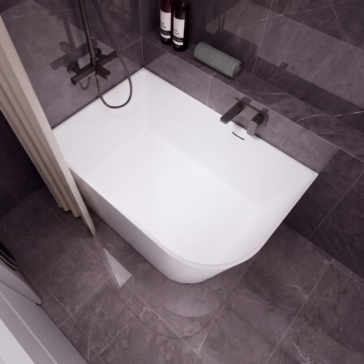 A modern white freestanding bathtub with a dark gray tiled bathroom setting, featuring a wall-mounted chrome faucet, a handheld shower attachment, and a beige curtain on the left.