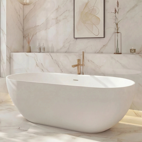 Modern bathroom with a freestanding bathtub, marble walls, and a large window.