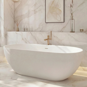 Modern bathroom with a freestanding bathtub, marble walls, and a large window.