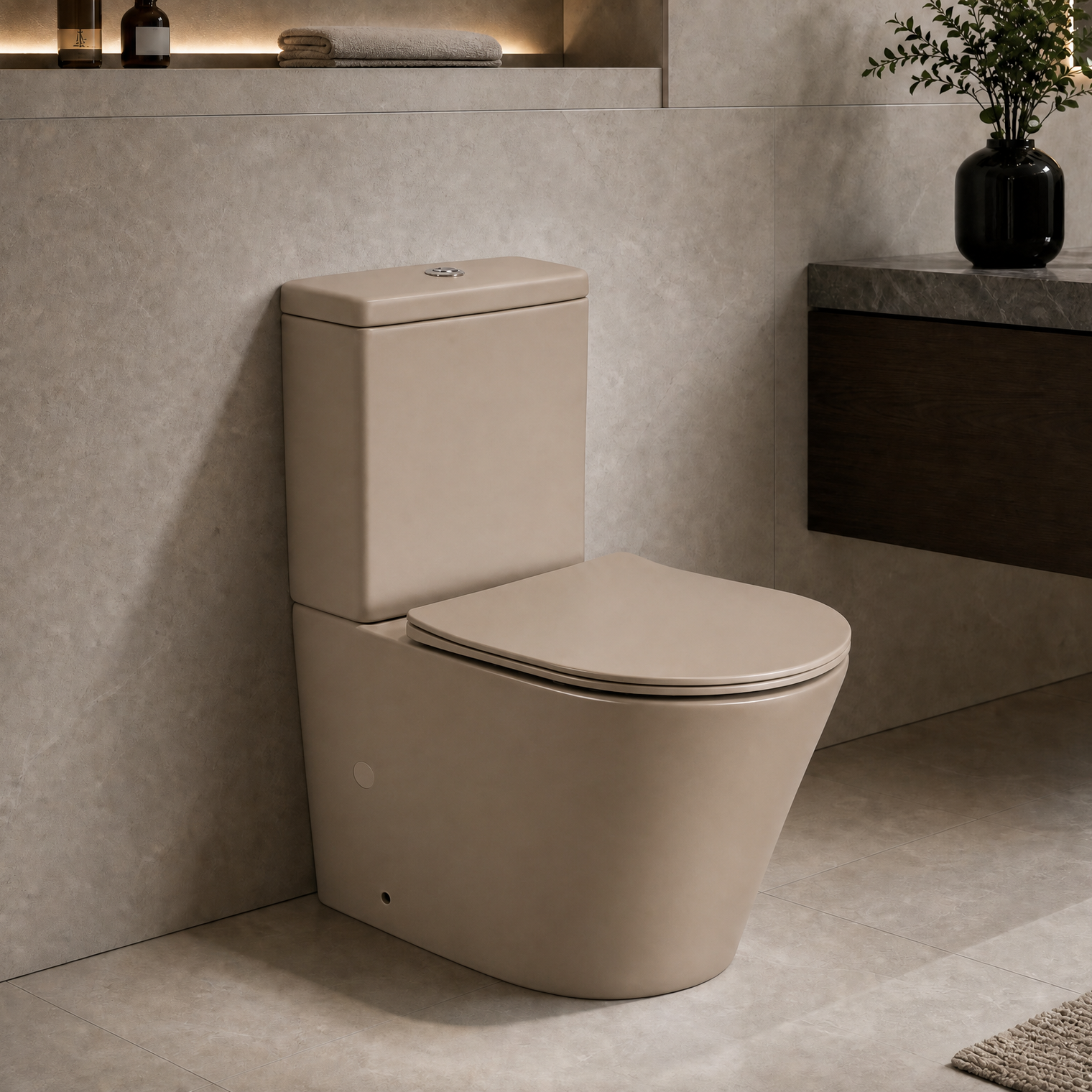 A modern 2-piece ceramic toilet in a warm beige/taupe color, shown installed in a contemporary bathroom with textured stone walls, a floating dark wood vanity, and a hanging sink.