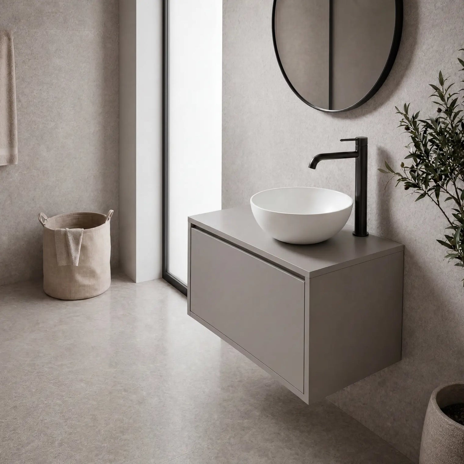 Modern bathroom with a floating vanity, round mirror, and plant.