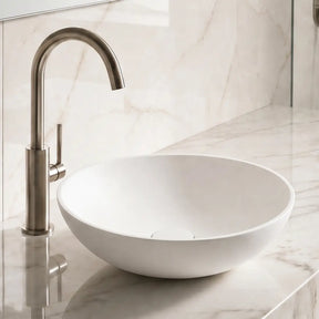 Bathroom sink with marble countertop and tiled wall