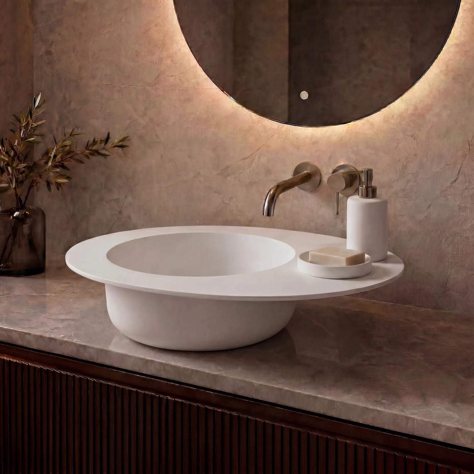 Modern bathroom vanity with a white sink, illuminated mirror, and decorative elements.