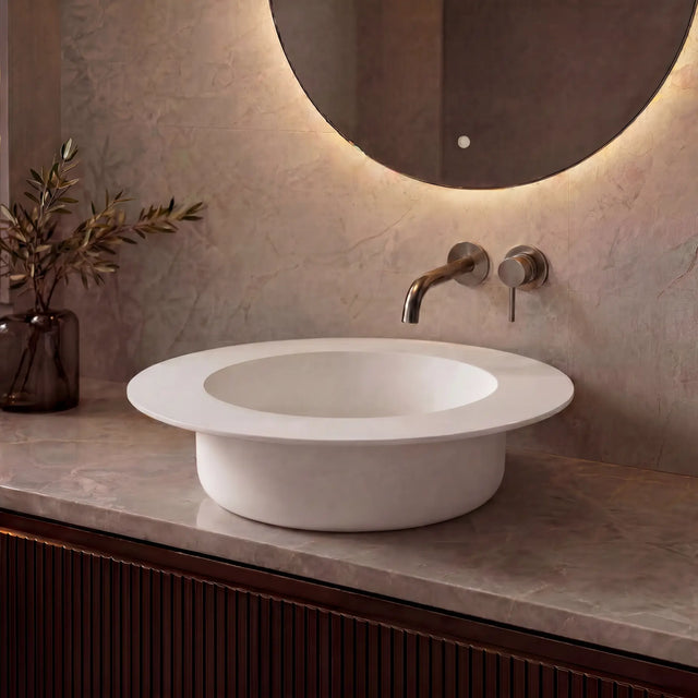 Modern bathroom sink with faucet against a neutral wall
