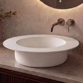 Modern bathroom sink with faucet against a neutral wall