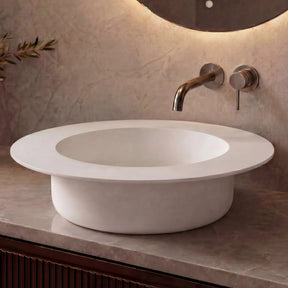 Modern bathroom sink with faucet against a neutral wall