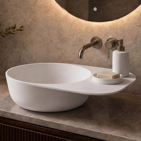 Modern bathroom vanity with a white sink, faucet, and decorative elements.