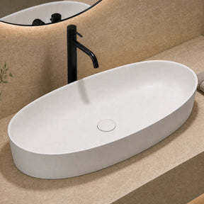 Bathroom vanity with white sink, black faucet, and decorative elements.