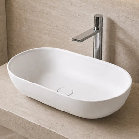 Modern bathroom with a white solid surfaces sink on a beige countertop