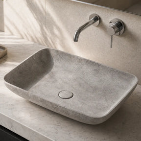 Bathroom vanity with a concrete sink and faucet